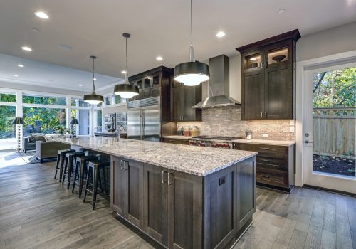 Modern,Kitchen,With,Brown,Kitchen,Cabinets,,Oversized,Kitchen,Island,With